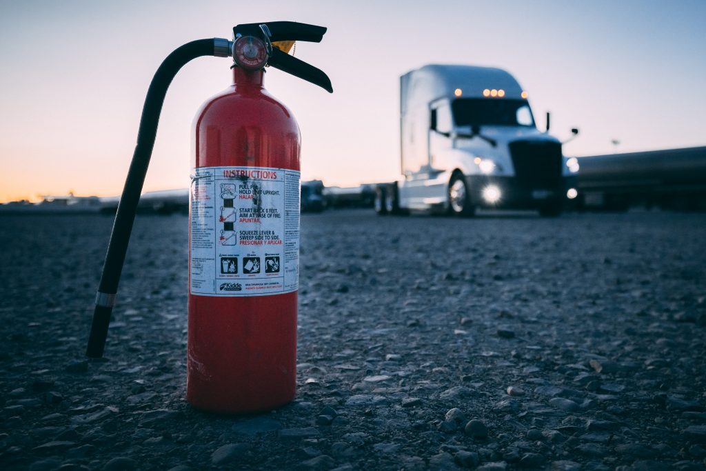 Fire extinguisher in front of truck.